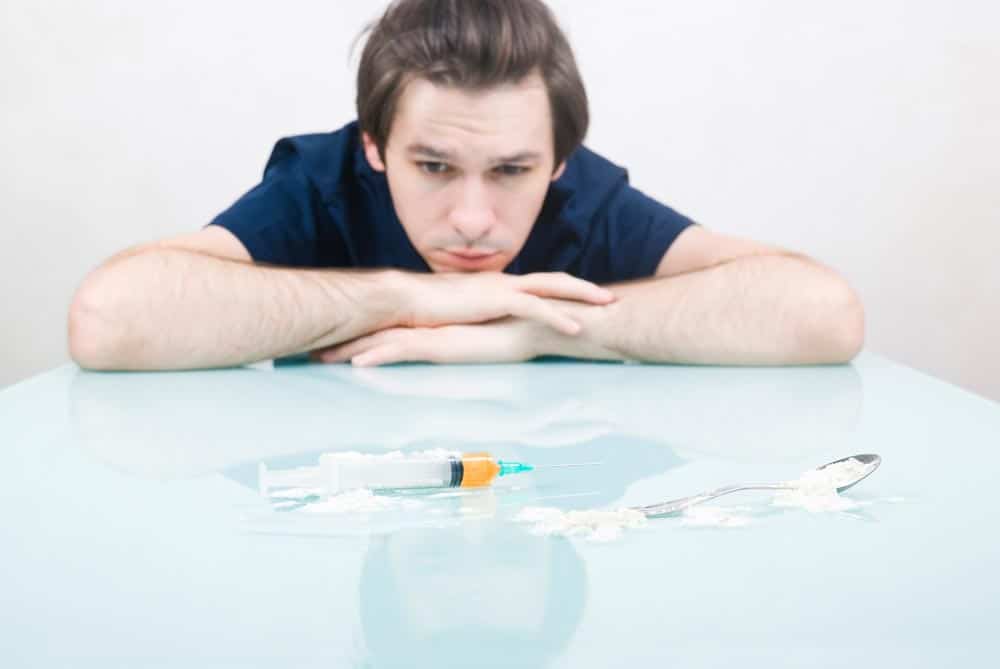 a lonely young man thinking of using substances to feel good