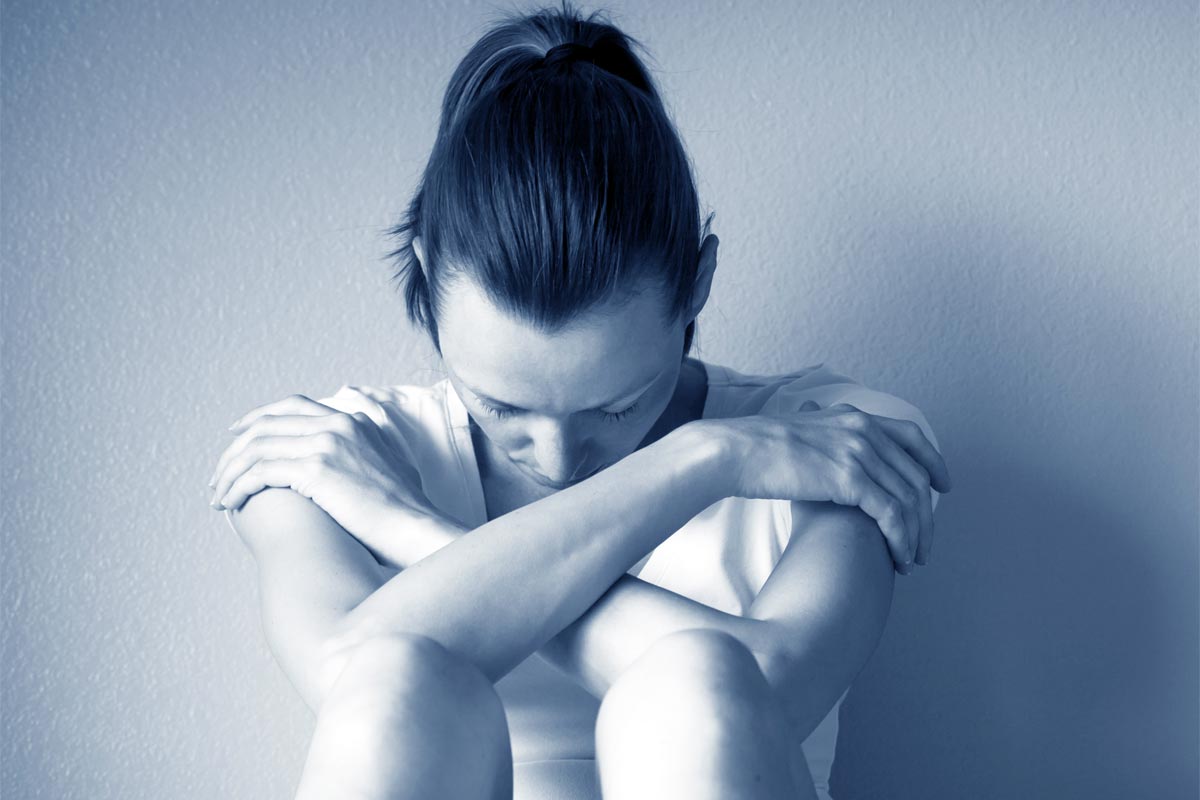 a woman sitting on the floor, the effect of the drug is extremely strong on her body